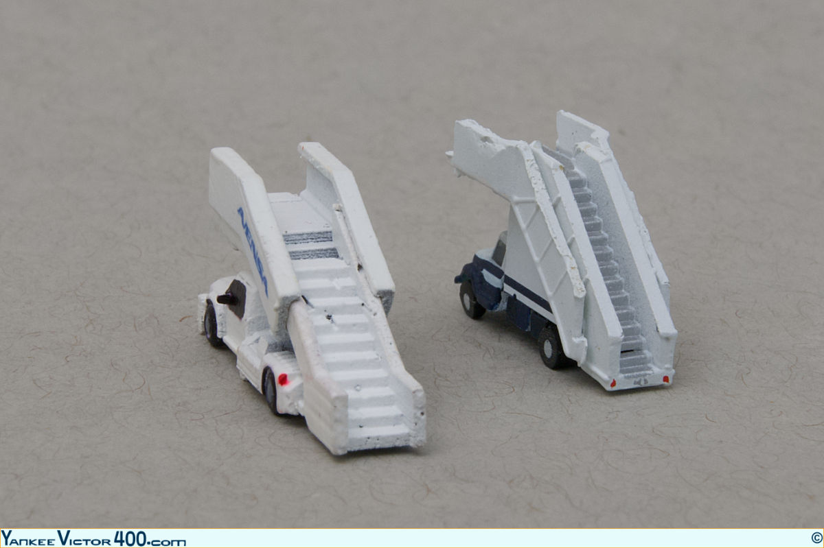 Two. set of air-stairs in 1:400 scale, one made by West Coast Diecast, and the other one by GeminiJets.